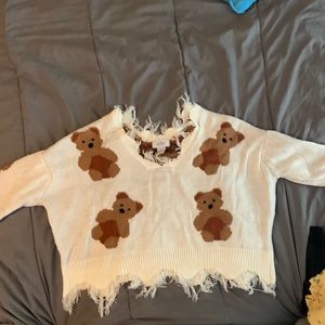I am selling a crop top that has bears on it and has strings coming out.